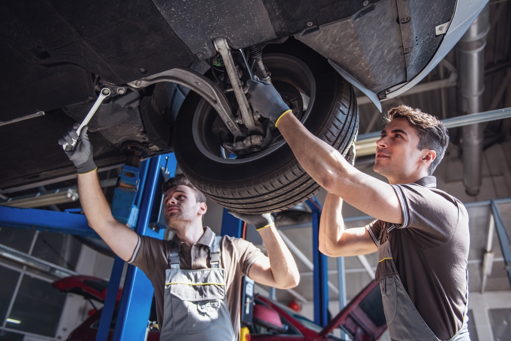Certified Mopar technicians performing suspension repair and wheel alignment, Jeep Grand Cherokee service Newnan GA, factory-trained Jeep mechanics, multi-point inspection, brake service, tire rotation and balancing, genuine Mopar parts, Newnan CDJR Service center near Ashley Park, schedule service online