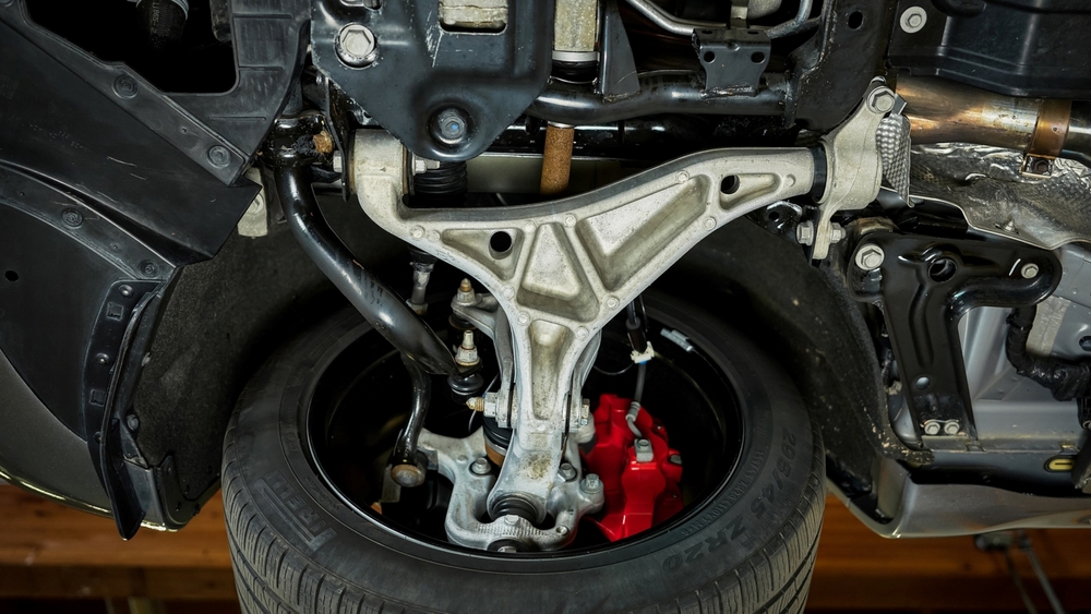 Jeep Grand Cherokee front suspension control arm and ball joint, wheel alignment inspection Newnan GA, suspension service Newnan CDJR, lower control arm recall check, tie rod and bushings, clunking over bumps, uneven tire wear, Mopar suspension parts Georgia, certified Jeep technician, Coweta County potholes impact