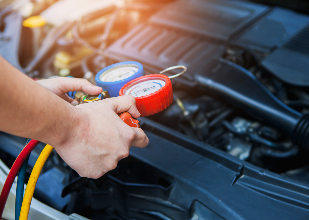 Nissan AC recharge service Charlotte, refrigerant pressure gauge AC diagnostic, East Charlotte Nissan compressor inspection, car air conditioning system repair, Nissan AC refrigerant test