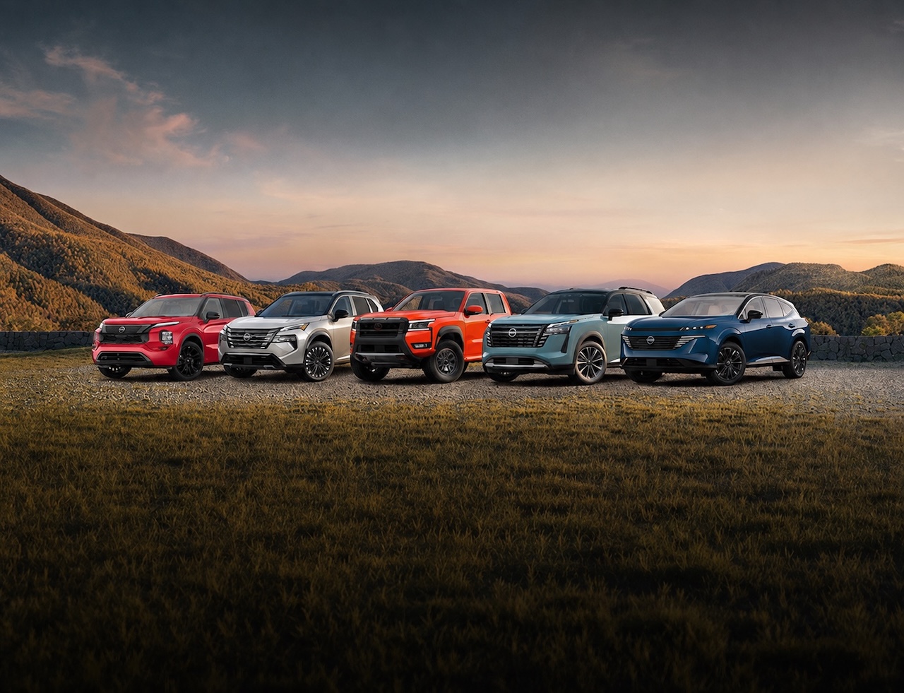 A lineup of Nissan vehicles with a mountain view, representing lease-end assistance from Stone Mountain Nissan