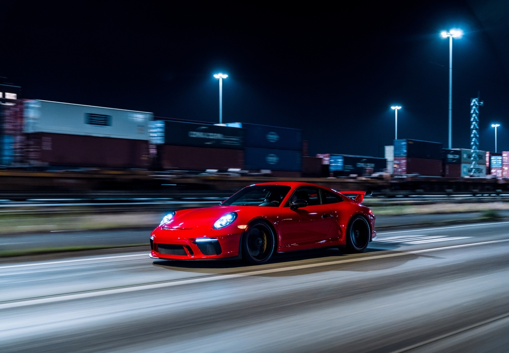Red Porsche 911 GT3 driving at night, Porsche sports car Naples FL, high-performance Porsche model, Porsche speed & power, luxury car driving experience, Porsche Fort Myers to Naples night drive, buy Porsche Naples FL, Porsche dealership Naples, new Porsche for sale Naples, Porsche lease deals Naples FL, how to buy a Porsche in Naples, custom Porsche Naples