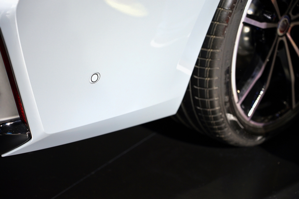 rear bumper sensor close-up, ADAS blind spot monitoring Naples, radar sensor inspection after collision, OEM parking sensor alignment, ADAS calibration sensor detail, luxury car collision repair Naples FL, Naples Premium Collision sensor repair