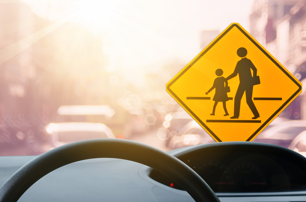 School zone warning sign safety, Mazda driving safety school commute Daytona Beach, school drop-off driving awareness, child safety Mazda CX-5, Mazda tire check school run safety Daytona