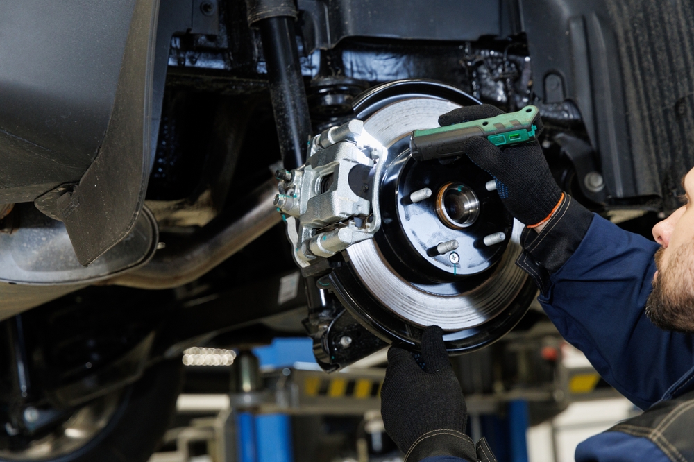 certified Nissan brake inspection Charlotte, close-up of rotor and caliper check, Scott Clark Nissan brake diagnostics, back to school brake pad replacement, brake fluid and rotor check Charlotte NC