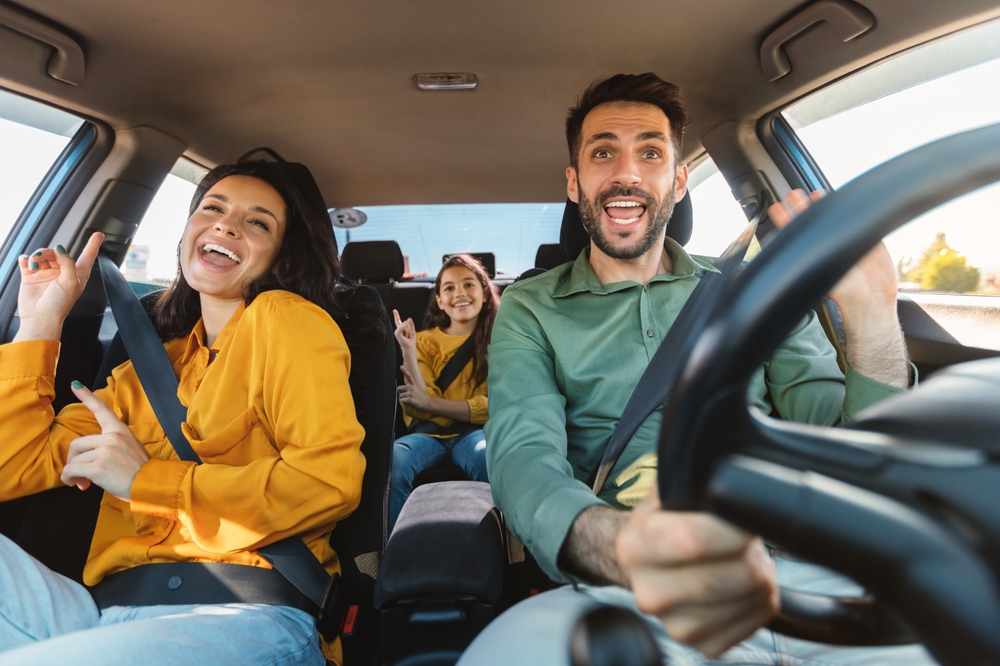 Happy family road trip in Nissan, Scott Clark Nissan Charlotte NC, cool A/C driving comfort, summer drive to Carowinds, family Nissan A/C service, reliable cooling Nissan Charlotte, Charlotte NC auto repair for summer, Nissan service near Uptown Charlotte, Nissan summer vacation ready