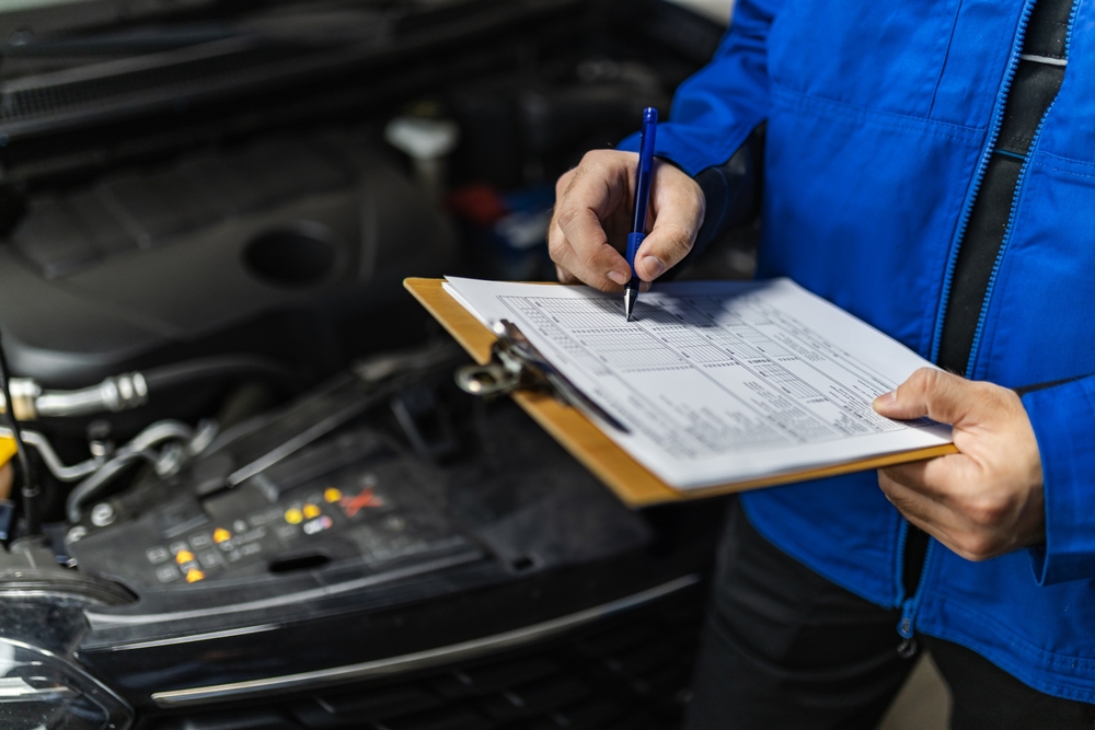 Service advisor completing inspection checklist, Gainesville Nissan EV service, Nissan Leaf battery health report, Gainesville FL dealership service, EV maintenance schedule, battery diagnostics and range concerns, schedule service online
