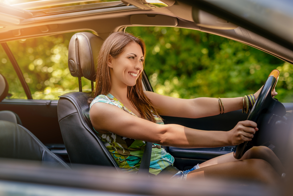 Happy driver enjoying cool air, Nissan A/C service Colorado Springs, car AC repair Colorado Springs, South Colorado Springs Nissan service, genuine Nissan parts, Colorado Springs auto AC
