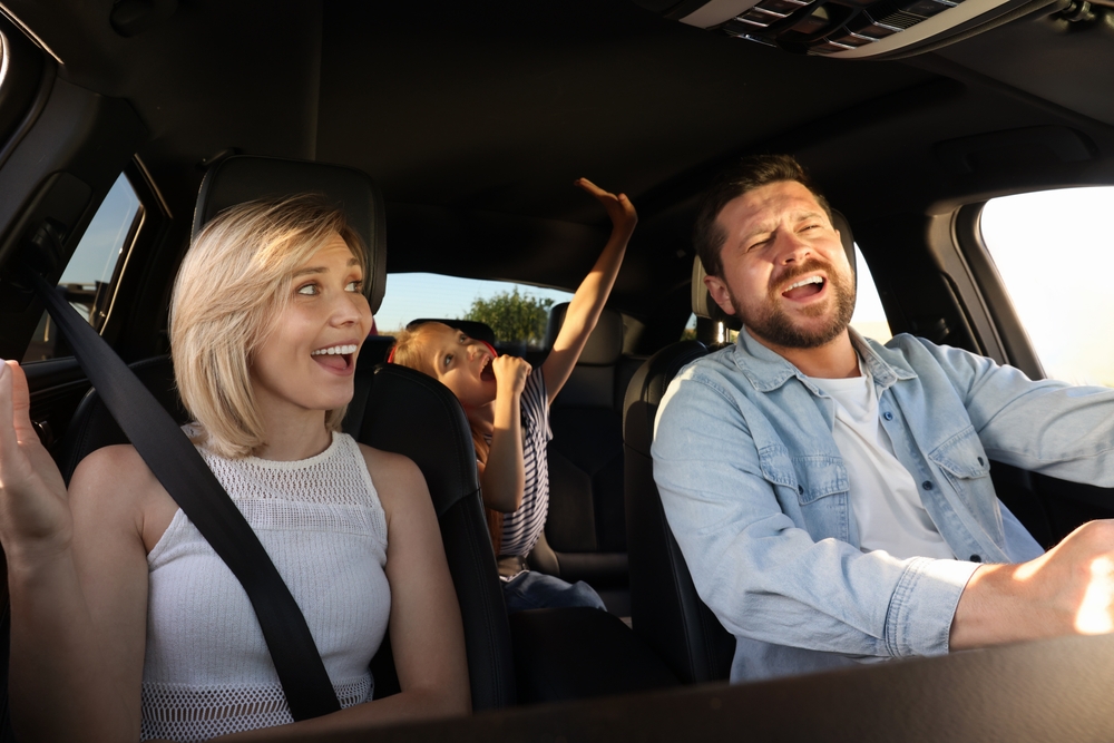 Happy family driving with cold A/C, Stone Mountain Nissan cabin comfort, Nissan dual-zone climate control Georgia, Atlanta Nissan road trip comfort, cool interior summer Nissan service, family-friendly A/C Nissan service Lilburn GA, Nissan summer drive cooling performance