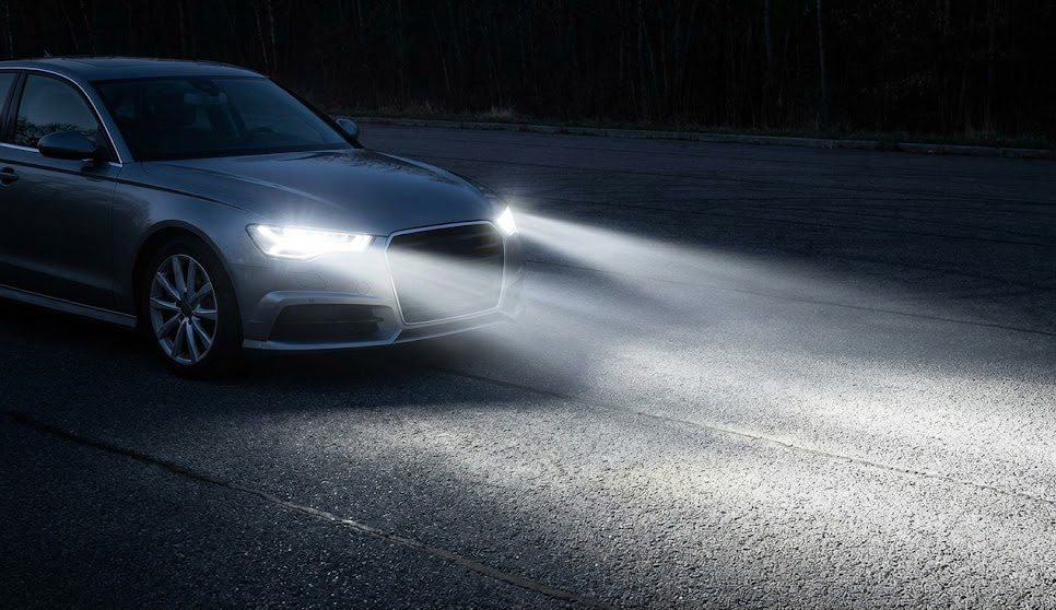 modern sedan with bright LED headlights, Nissan LED headlight upgrade Stone Mountain, crisp white headlights on dark Georgia road, improved nighttime visibility near Lilburn, upgrade from halogen to LED headlights, Nissan Altima and Rogue LED lighting, headlight safety Highway 78 Stone Mountain GA, Stone Mountain Nissan Service lighting upgrades, LED bulbs for better reaction time, Georgia nighttime driving safety