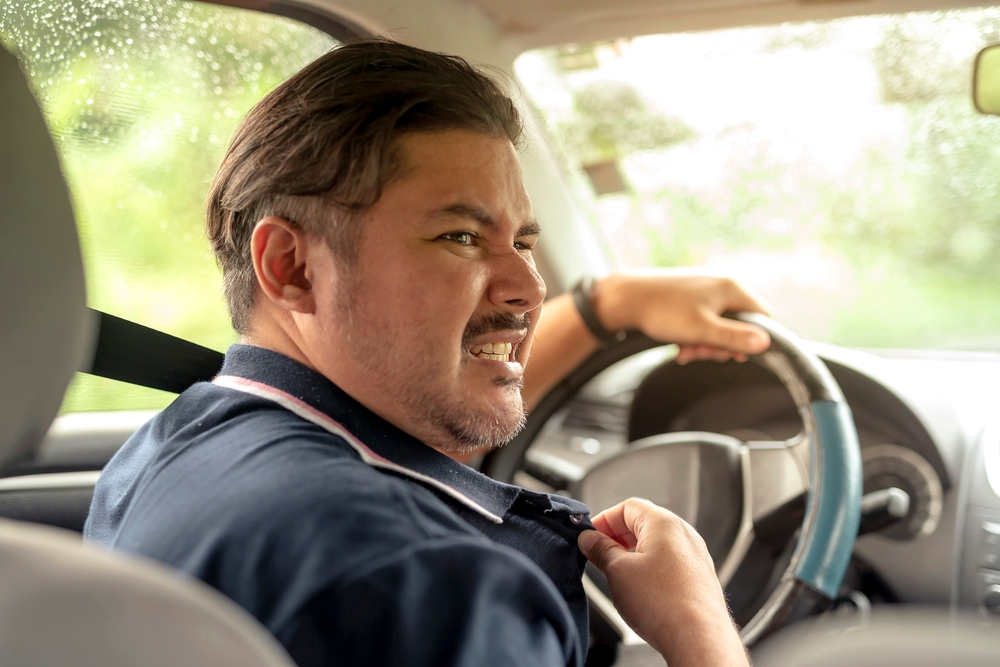 Driver suffering in hot car Georgia, Nissan A/C failure symptoms Stone Mountain, Lilburn summer car heat discomfort, Nissan cooling issues Atlanta area, signs of A/C repair needed, Georgia humidity car problems, overheating cabin Stone Mountain Nissan service