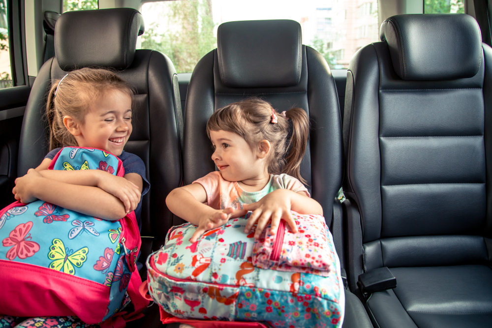 Volkswagen backseat with kids, school drop-off VW SUV interior Snellville, safe back to school car ride Stone Mountain VW, children in VW with backpacks, comfortable family school commute in Volkswagen