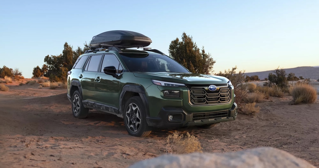 Green Subaru Outback on an unpaved trail, hero image for Subaru lease return help at AutoFair Subaru of Haverhill
