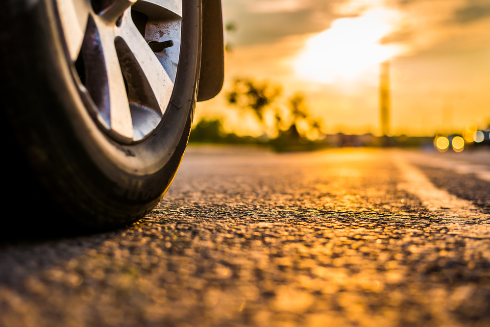 close-up summer tire on hot Georgia asphalt, tire rotation Stone Mountain GA, summer tire heat damage, Nissan tire wear from heat, summer driving conditions Georgia, tire safety in Stone Mountain heat