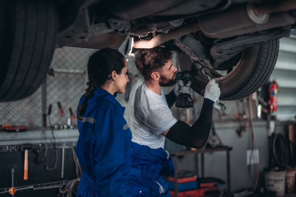 certified technician performing Nissan wheel alignment, summer alignment service Stone Mountain GA, tire rotation and wheel adjustment, Nissan Express Service alignment, Georgia road-ready tire prep