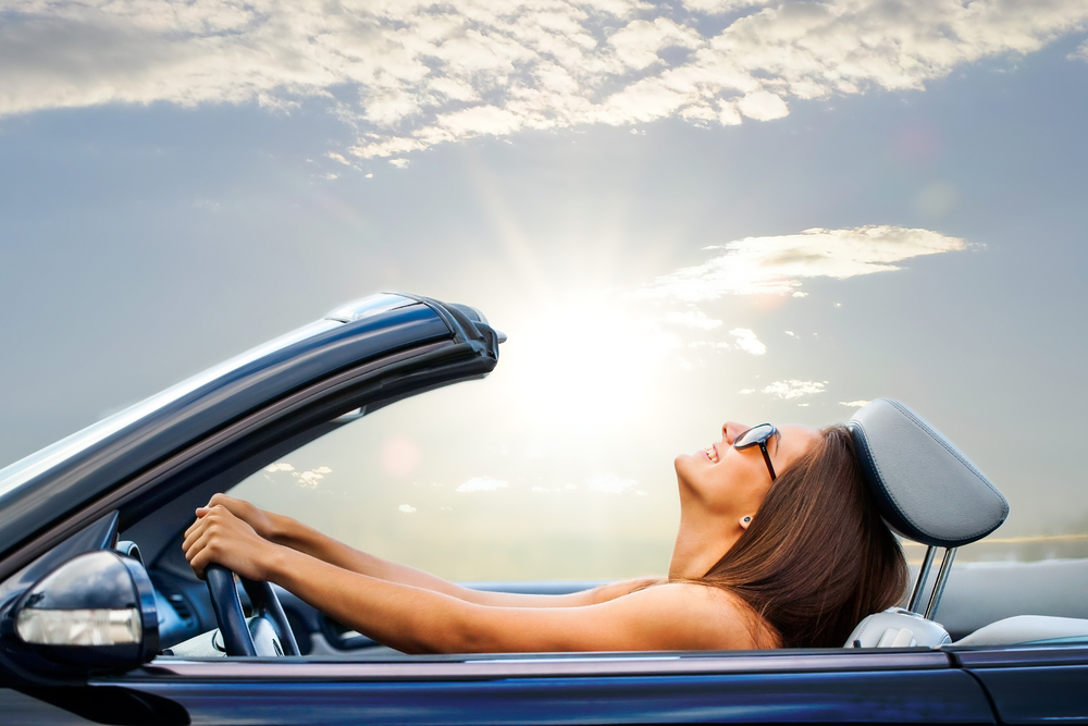 Happy Toyota driver Knoxville TN, summer-ready Toyota car battery, reliable starts in Tennessee heat, Toyota convertible joy ride, summer road trip with TrueStart battery, Toyota maintenance peace of mind Knoxville