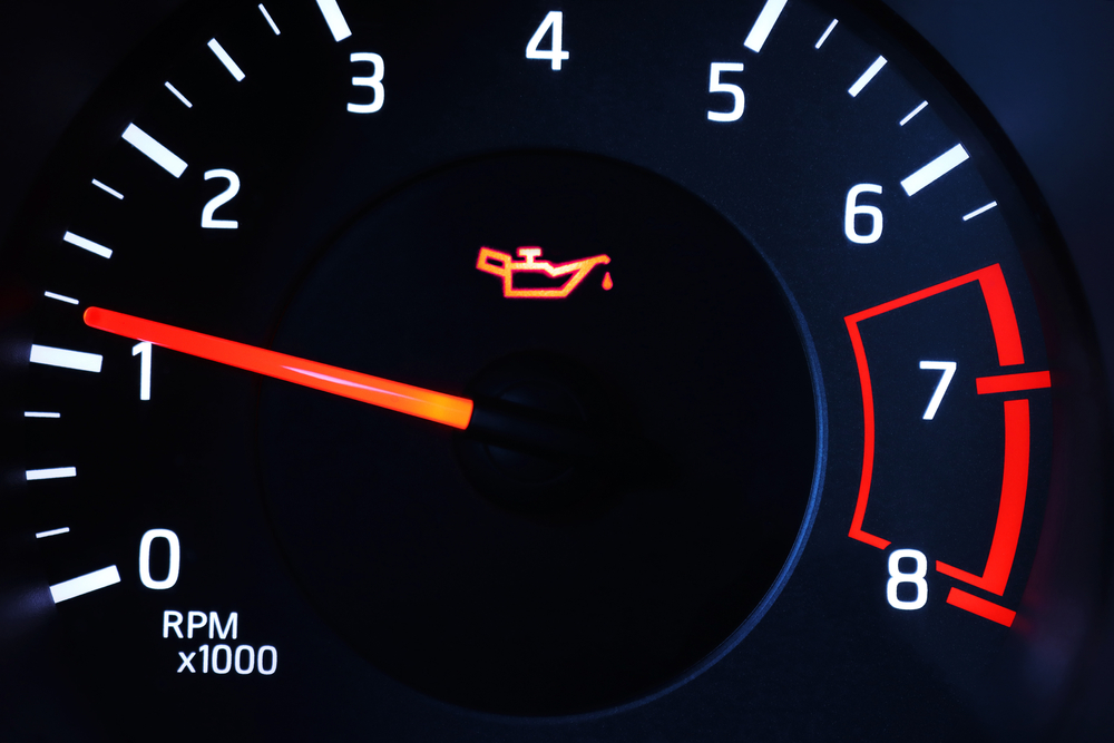 Nissan dashboard oil warning light indicator, signs you need an oil change Colorado Springs, Woodmen Nissan service center oil maintenance alert, high-altitude engine stress warning, Nissan vehicle oil change light illuminated, schedule certified oil service Nissan dealer