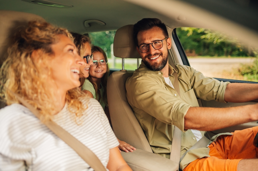 happy family driving Nissan after brake service, Colorado Springs safe mountain travel, peace of mind Nissan service, Woodmen Nissan customer satisfaction, mountain road readiness check, brake service before family road trip